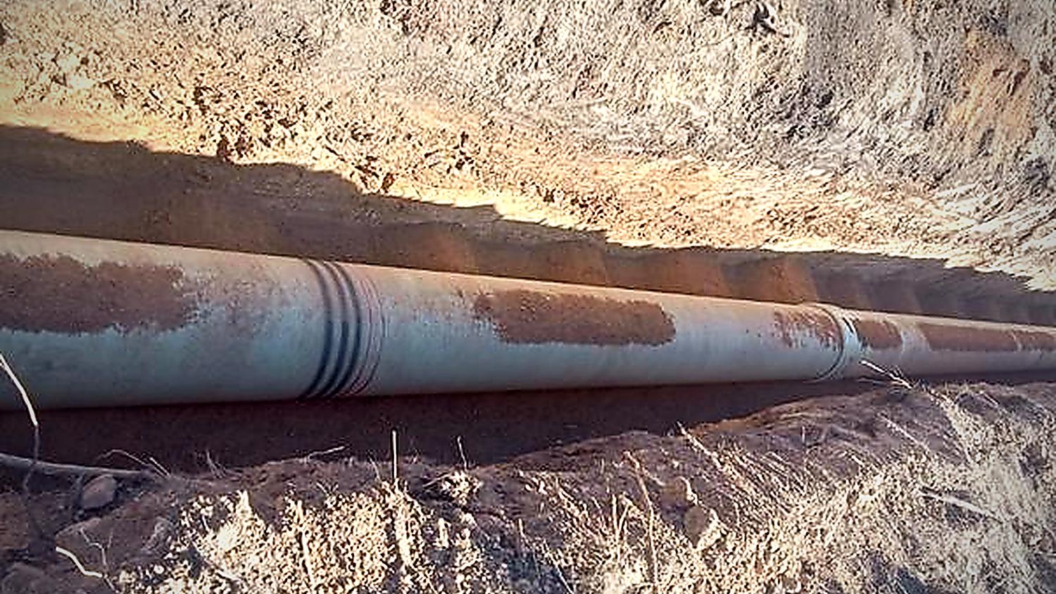 Steel bulk water pipeline laid and welded in an open excavation